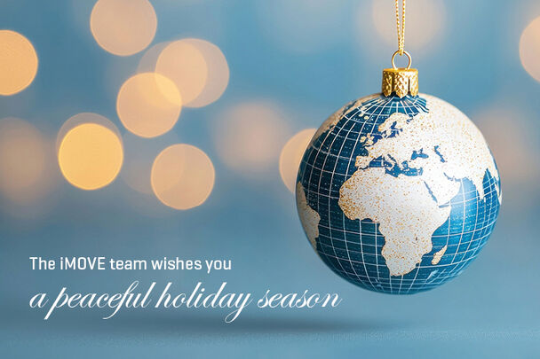 Christmas bauble with a world map, text: the iMOVE team wishes you a peaceful holisday season