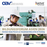 A young Chinese woman in a training workshop files a workpiece that is clamped in a vice