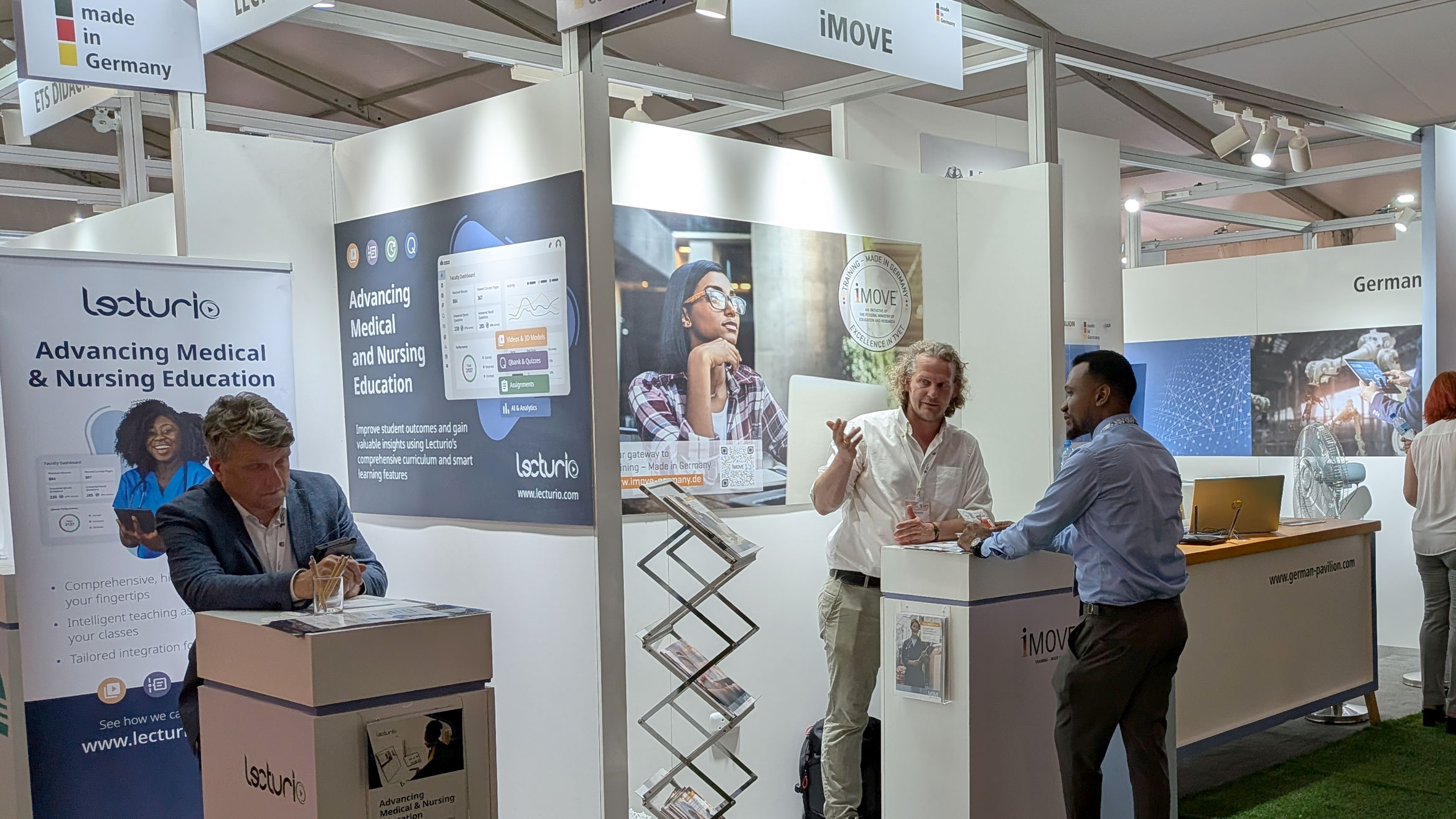 Two men in conversation at the exhibition stand