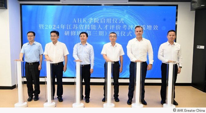 six men stand in front of little columns, each with a start buzzer