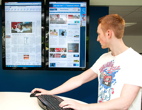 young man using a keybord and watching screens